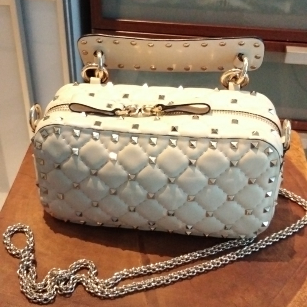 Valentino Garavani Rockstud Spike Lamb Leather bag in cream with gold hardware.